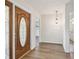 Elegant foyer with a decorative front door, and views into the dining and kitchen areas at 1443 54Th Ne Ave, St Petersburg, FL 33703
