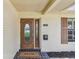 Detailed view of the front door with decorative glass, welcome mat, and address numbers at 1443 54Th Ne Ave, St Petersburg, FL 33703