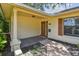 Inviting front entrance with a decorative front door, black tiled porch, and freshly manicured landscaping at 1443 54Th Ne Ave, St Petersburg, FL 33703