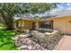 Charming home featuring manicured flower beds, beautiful exterior brickwork, and inviting landscaping at 1443 54Th Ne Ave, St Petersburg, FL 33703