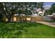 Charming single-story home with large front yard, mature trees, and an attached two-car garage at 1443 54Th Ne Ave, St Petersburg, FL 33703