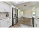 Modern kitchen featuring stainless steel appliances and white cabinets connecting to living area at 1443 54Th Ne Ave, St Petersburg, FL 33703
