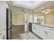 Modern kitchen with stainless steel appliances, white cabinetry and view of living space at 1443 54Th Ne Ave, St Petersburg, FL 33703