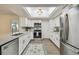 Updated kitchen with white cabinets, stainless appliances, and modern countertops at 1443 54Th Ne Ave, St Petersburg, FL 33703