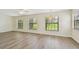 Spacious living room with large windows that provide a view of the outdoor scenery at 1443 54Th Ne Ave, St Petersburg, FL 33703