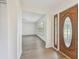 Entry way shot featuring a light filled living room with neutral paint and luxury vinyl flooring at 1443 54Th Ne Ave, St Petersburg, FL 33703