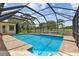 Screened-in pool featuring brick trim, a blue-tiled water line, and a clear view of the golf course at 1443 54Th Ne Ave, St Petersburg, FL 33703