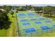 A community complex featuring multiple blue and green tennis courts at 1443 54Th Ne Ave, St Petersburg, FL 33703