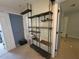 View of the bedroom, with custom shelving, neutral paint and door to hallway at 1015 Windton Oak Dr, Ruskin, FL 33570