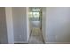 Hallway with white walls and a view of the bright open kitchen at 1015 Windton Oak Dr, Ruskin, FL 33570