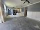 Open living and kitchen space with a ceiling fan, stainless steel appliances, island and modern lighting at 1015 Windton Oak Dr, Ruskin, FL 33570