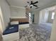 An open living room space featuring bright gray walls, staircase, ceiling fan and shiplap accent wall at 1015 Windton Oak Dr, Ruskin, FL 33570