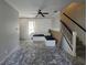 Bright living room with ceiling fan, large windows, staircase, gray walls, and built in bench seating at 1015 Windton Oak Dr, Ruskin, FL 33570