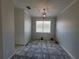 Bright room with a modern light fixture, window and light gray walls at 1015 Windton Oak Dr, Ruskin, FL 33570