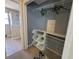 Showing walk-in closet, organizer rack, and access to bathroom with glass shower at 1015 Windton Oak Dr, Ruskin, FL 33570