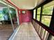 Tiled sunroom featuring bright natural light, painted brick, and convenient sliding door access to living area at 1025 82Nd N Ter # 1025D, St Petersburg, FL 33702