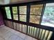 Bright enclosed balcony featuring light tile flooring, brick accents, and lots of natural light at 1025 82Nd N Ter # 1025D, St Petersburg, FL 33702