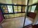 Enclosed porch with brick accents, tile flooring, and several windows with views of lush greenery at 1025 82Nd N Ter # 1025D, St Petersburg, FL 33702