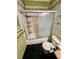 Bathroom features a shower/tub combo with sliding glass doors, vanity and black granite floors at 1025 82Nd N Ter # 1025D, St Petersburg, FL 33702