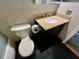 Bathroom displaying a toilet and vanity with a granite countertop and dark cabinets at 1025 82Nd N Ter # 1025D, St Petersburg, FL 33702