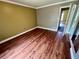 Cozy bedroom featuring hardwood floors and view of a door at 1025 82Nd N Ter # 1025D, St Petersburg, FL 33702