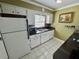 Kitchen with white cabinets, stone countertops and stainless steel appliances at 1025 82Nd N Ter # 1025D, St Petersburg, FL 33702