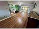 Spacious living room with natural light, wood floors, and sliding doors to screened lanai at 1025 82Nd N Ter # 1025D, St Petersburg, FL 33702