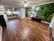 Open living area with wood flooring and an accent wall with a waterfall mural at 1025 82Nd N Ter # 1025D, St Petersburg, FL 33702