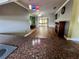 Open living area with wood flooring, a waterfall mural accent wall, and colorful pendant lights at 1025 82Nd N Ter # 1025D, St Petersburg, FL 33702