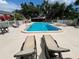 A community pool and lounge area, with seating and plenty of room to relax at 1025 82Nd N Ter # 1025D, St Petersburg, FL 33702