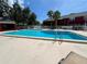 Large, clean pool with ladders for easy access and lounge seating nearby at 1025 82Nd N Ter # 1025D, St Petersburg, FL 33702