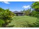 Large grassy backyard with mature trees and a screened-in porch at 12004 Legacy Bright St, Riverview, FL 33578