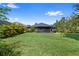 Expansive backyard with lush green grass and a screened-in lanai at 12004 Legacy Bright St, Riverview, FL 33578