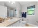 Bright bathroom featuring a granite countertop, framed mirror, and tiled floor at 12004 Legacy Bright St, Riverview, FL 33578