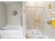 Bright, clean bathroom featuring a separate shower and tub, with neutral tile work and plenty of light at 12004 Legacy Bright St, Riverview, FL 33578