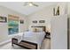 Bedroom with a large window offering a verdant view and featuring a stylish ceiling fan at 12004 Legacy Bright St, Riverview, FL 33578