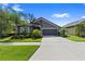Charming single-story home with a well-manicured lawn and two-car garage at 12004 Legacy Bright St, Riverview, FL 33578