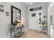 Bright foyer boasts tile floors, a decorative mirror, console table, and natural light streaming through the front door at 12004 Legacy Bright St, Riverview, FL 33578