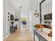 Inviting hallway featuring tile flooring, neutral walls, decorative accents, and a view into the dining area at 12004 Legacy Bright St, Riverview, FL 33578