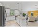 Bright kitchen featuring stainless steel appliances, granite countertops, island, and open layout to living area at 12004 Legacy Bright St, Riverview, FL 33578
