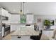 Modern kitchen with white cabinets, granite countertops, stainless steel appliances, and a spacious island at 12004 Legacy Bright St, Riverview, FL 33578