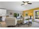 Bright living room with tile floors, comfortable white seating, and a modern entertainment center at 12004 Legacy Bright St, Riverview, FL 33578