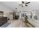 Open concept living space with dining area, kitchen, and modern furnishings on tile flooring at 12004 Legacy Bright St, Riverview, FL 33578