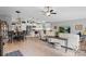 Bright, open-concept living and dining area featuring white cabinetry and stainless steel appliances at 12004 Legacy Bright St, Riverview, FL 33578
