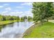 Scenic pond featuring a fountain, surrounded by lush green landscaping and mature trees at 12004 Legacy Bright St, Riverview, FL 33578