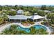 Aerial view of the community pool with cabana, sun loungers, and tropical landscaping at 12004 Legacy Bright St, Riverview, FL 33578