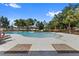 Community pool with lounge chairs, palm trees, and a bright blue sky backdrop at 12004 Legacy Bright St, Riverview, FL 33578