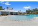 Community pool and pavilion with lounge chairs, lush landscaping, and clear blue skies at 12004 Legacy Bright St, Riverview, FL 33578