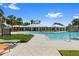 Community pool with outdoor lounge seating, tropical plants, and a large pavilion area at 12004 Legacy Bright St, Riverview, FL 33578