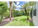 This serene backyard features tropical landscaping and mature trees for ultimate privacy at 1208 Carriage Park Dr, Valrico, FL 33594